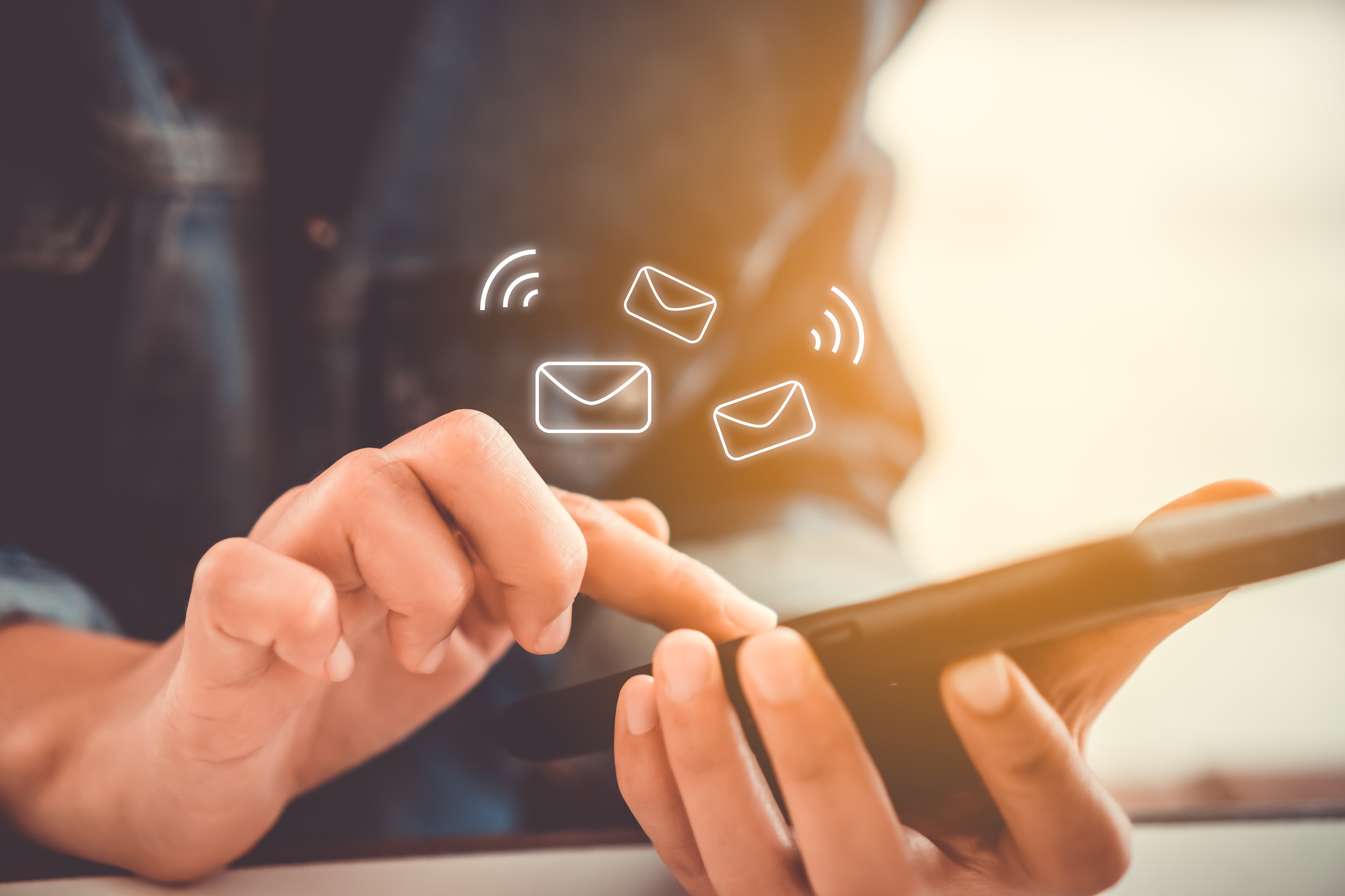 image of someone scrolling through emails on their phone